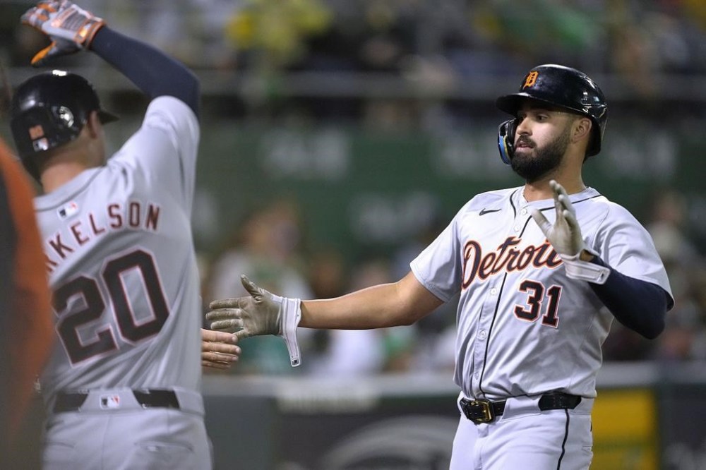 Detroit Tigers' Riley Greene (31) is congratulated by Spencer Torkelson (20) after scoring on an Oakland Athletics wild pitch during the seventh inning of a baseball game Friday, Sept. 6, 2024, in Oakland, Calif. (AP Photo/Tony Avelar)
