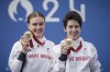 Great Britain's Sophie Unwin, right, and her pilot Jenny Holl pose with their gold medals after winning the Women's B Road Race during the 2024 Paralympics, Friday, Sept. 6, 2024, in Clichy-sous-Bois, France. (AP Photo/Aurelien Morissard)