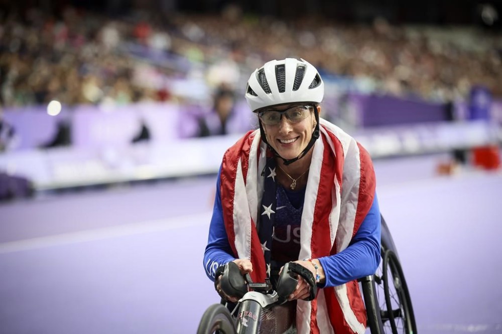 Tatyana McFadden of the U.S., celebrates before being informed she has been disqualified of the women's 400 m. T54 at the 2024 Paralympics, Thursday, Sept. 5, 2024, in Paris, France. (AP Photo/Thomas Padilla)