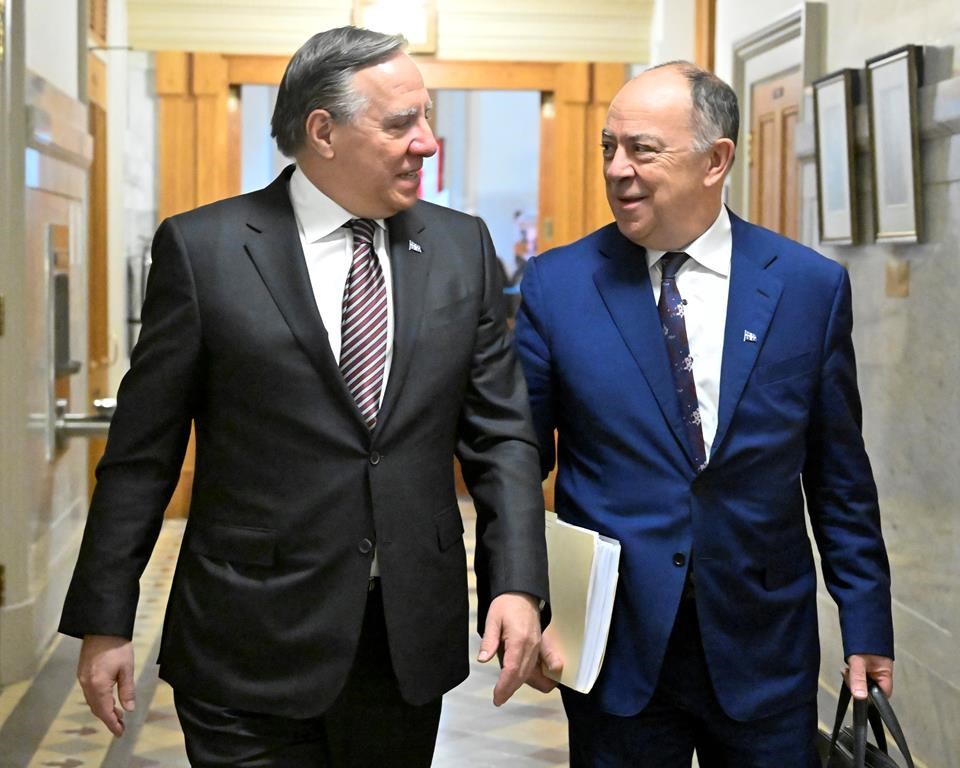Quebec Premier Francois Legault, left, walks to a cabinet meeting with Quebec Health Minister Christian Dube in Quebec City, Wednesday, March 29, 2023. Quebec announced Saturday that it will authorize early requests for medical assistance in dying, without waiting for Ottawa to amend Canada’s Criminal Code. THE CANADIAN PRESS/Jacques Boissinot