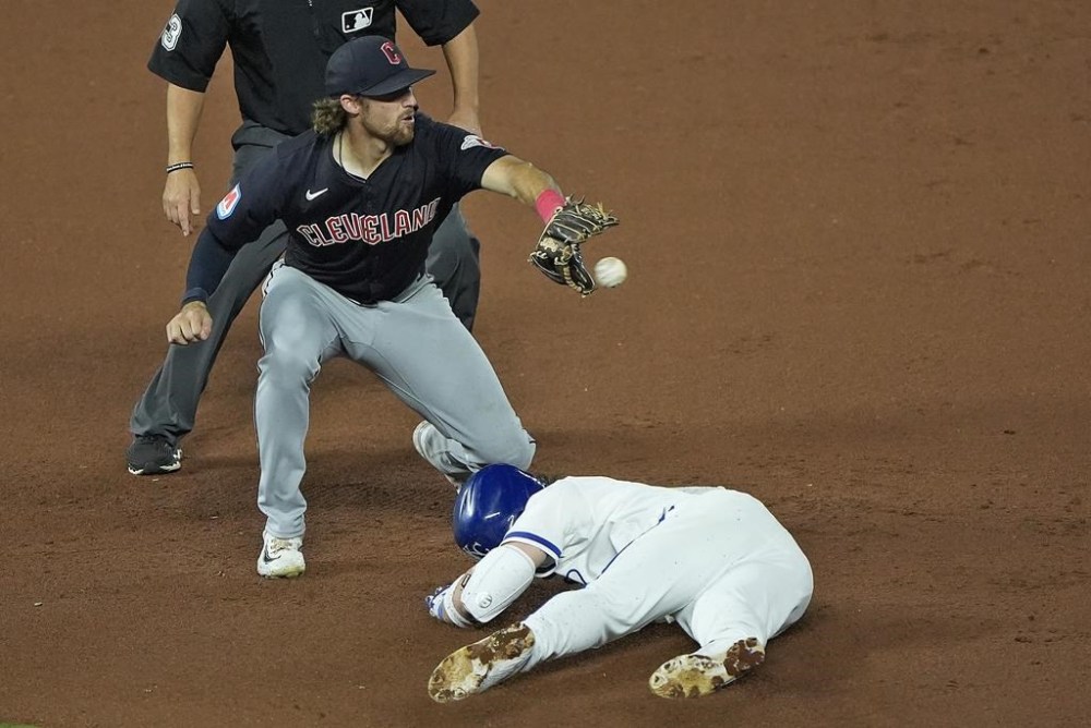 Kansas City Royals' Bobby Witt Jr. beats the tag at second by Cleveland Guardians shortstop Daniel Schneemann after hitting a double during the seventh inning of a baseball game Wednesday, Sept. 4, 2024, in Kansas City, Mo. (AP Photo/Charlie Riedel)