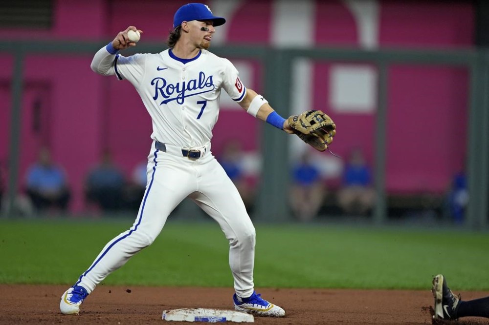 Kansas City Royals shortstop Bobby Witt Jr. throws to first for the double play hit into by Cleveland Guardians' Kyle Manzardo after forcing Will Brennan out at second during the fourth inning of a baseball game Wednesday, Sept. 4, 2024, in Kansas City, Mo. (AP Photo/Charlie Riedel)