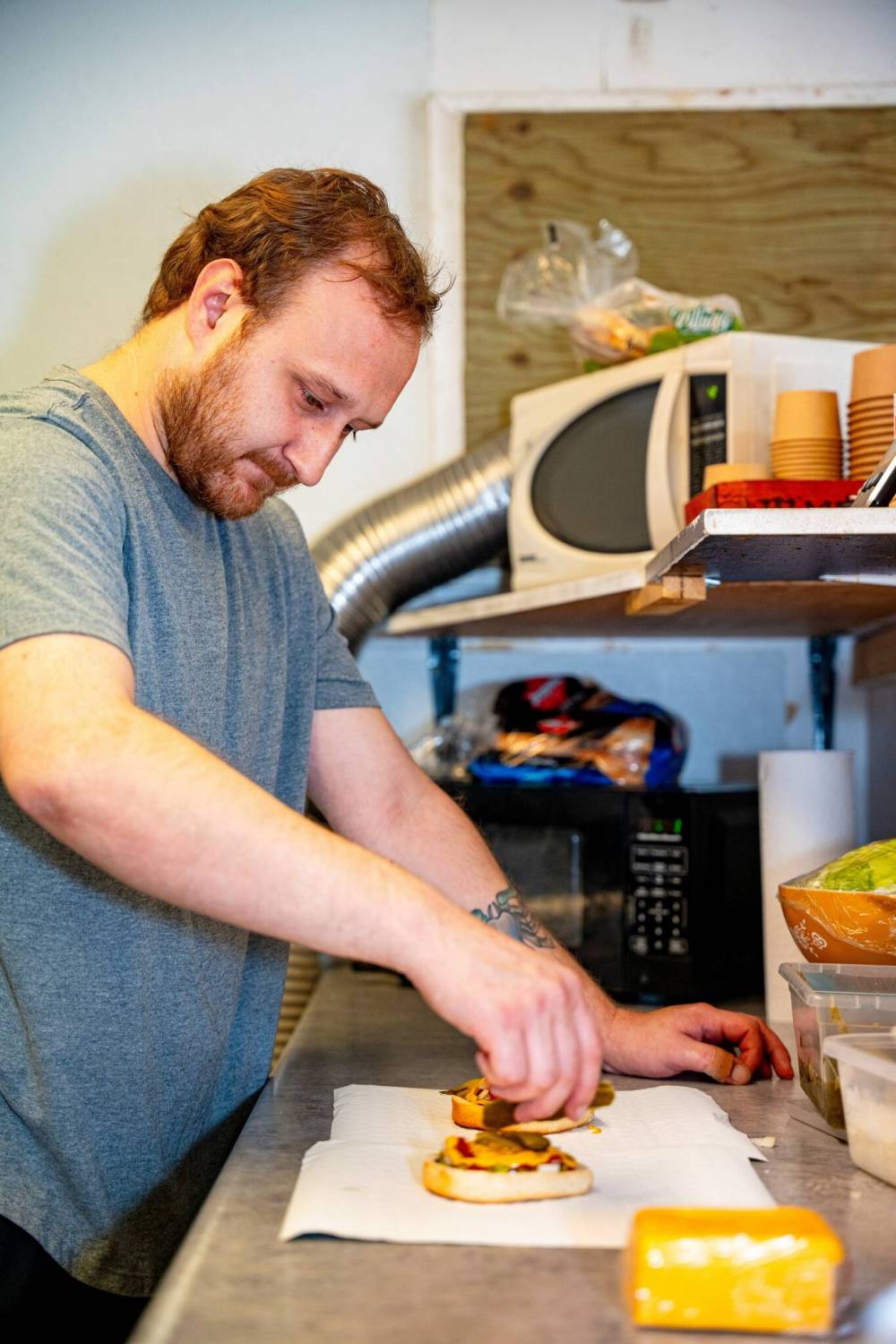 NIC ADAM / FREE PRESS
                                Brenden Galbichka builds a burger.