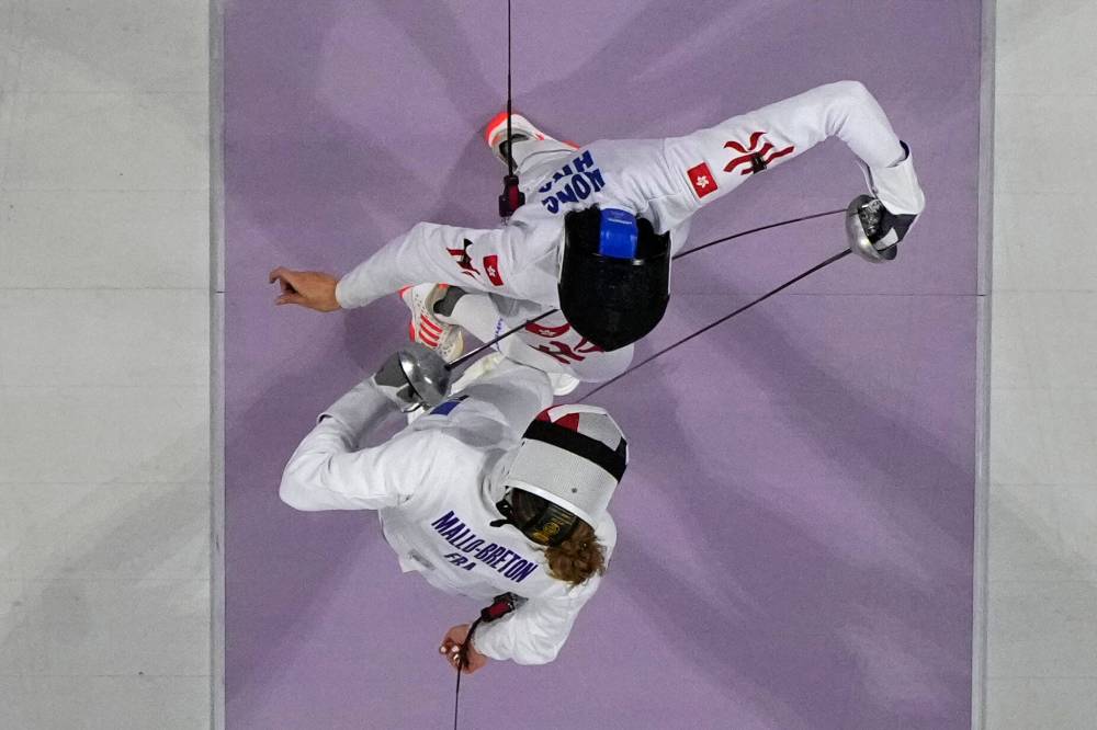Christophe Ena / The Associated Press
France’s Auriane Mallo-Breton (bottom) and Hong Kong’s Vivian Kong Man Wai compete in the women’s individual Epée final last Saturday in Paris.
