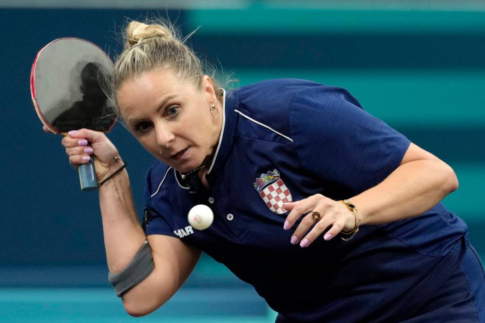 Petros Giannakouris / The Associated Press
Croatia’s Ivana Malobabic faces Singapore’s Zeng Jian during a round-of-64 singles table tennis game Sunday in Paris.