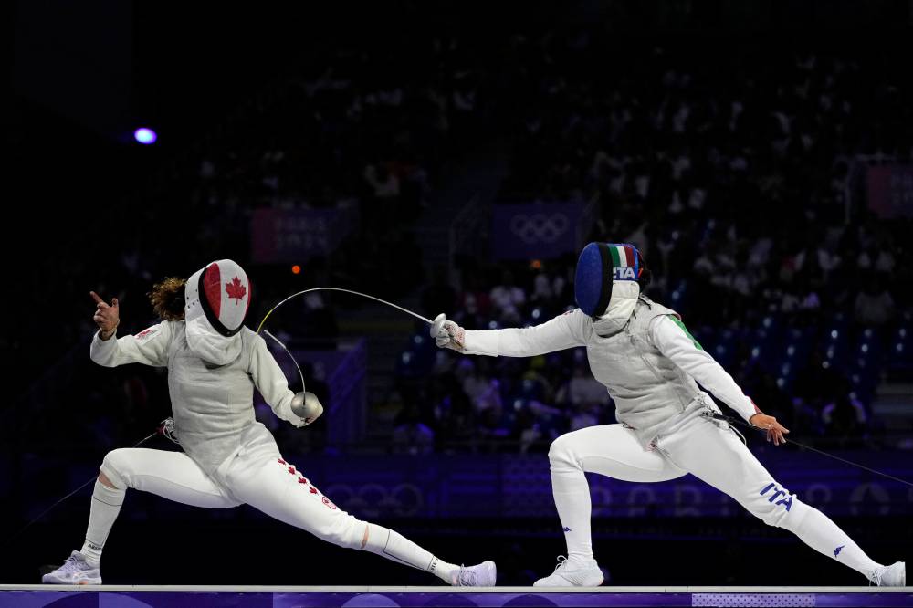 Andrew Medichini / The Associated Press
Canada’s Eleanor Harvey (left) faces Italy’s Alice Volpi in the women’s individual Foil bronze final match Sunday in Paris.