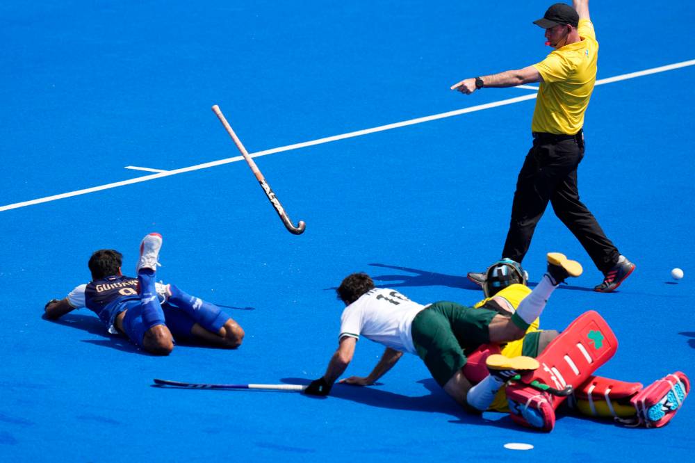 Aijaz Rahi / The Associated Press
India’s Gurjant Singh (left) loses his field-hockey stick after colliding with Ireland’s David Harte and Daragh Walsh during action Tuesday in Colombes, France.