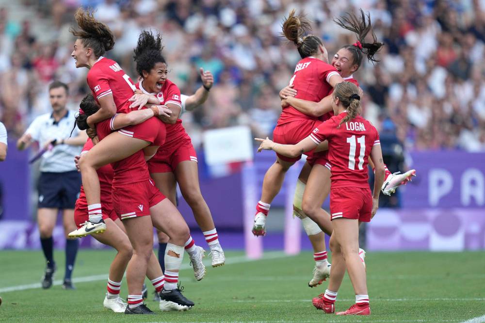 Tsvangirayi Mukwazhi / The Associated Press
Members of the Canadian women’s team celebrate winning the semifinal rugby sevens match against Australia Tuesday in Saint-Denis, France.