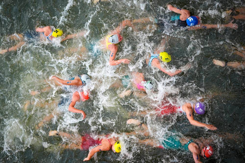 David Goldman / The Associated Press
Australia’s Natalie Van Coevorden (centre), competes in the swim leg of the women’s individual triathlon Wednesday in Paris.