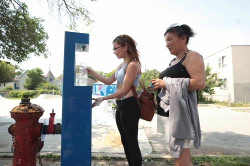 Ruth Bonneville / Free Press
                                Madison and her mom Priscilla stop to fill up a water bottle at one of eight hydration stations the city has installed in recent years. The stations are part of the city&rsquo;s response to extreme heat concerns.