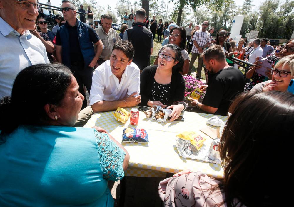 Prime Minister Justin Trudeau meets with healthcare workers and others Tuesday during an outdoor lunch at Victoria General Hospital sponsored by Winnipeg South Liberal MP Terry Duguid. (John Woods / The Canadian Press)