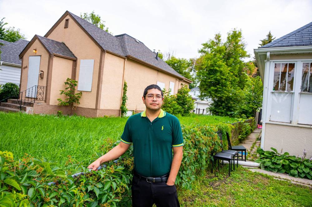 NIC ADAM / FREE PRESS
Ed Artola, pictured outside his property Wednesday, is a Winnipeg landlord who blames a vacant house next door for preventing him from being able to sell a home he owns and rents out on Atlantic Avenue.