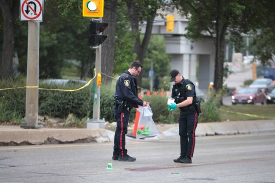 Winnipeg police investigate a collision on Main Street at Mayfair Thursday that killed a man. (Ruth Bonneville / Free Press)