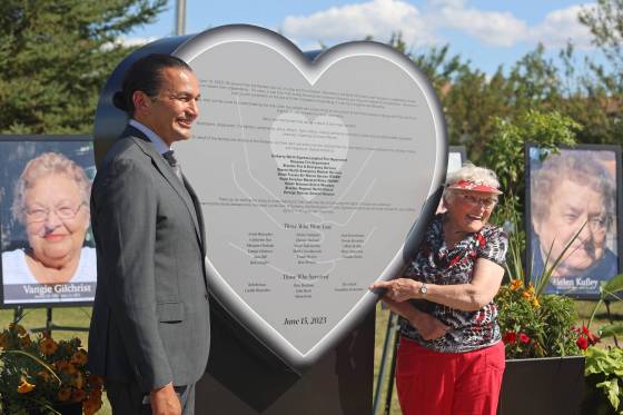 Manitoba Premier Wab Kinew and Josephine (Jo) Stokoteiny, one of the survivors of the collision near Carberry between a semi-truck and a bus full of seniors, with a monument unveiled in Carberry. (Abiola Odutola/The Brandon Sun)