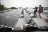 RUTH BONNEVILLE / FREE PRESS
                                Former principal Alain Michalik (right) and Amarbeer Bhandari, director of facilities, maintenance and transportation, stand on the rooftop of Collège Jeanne-Sauvé looking at the long line of solar panels.