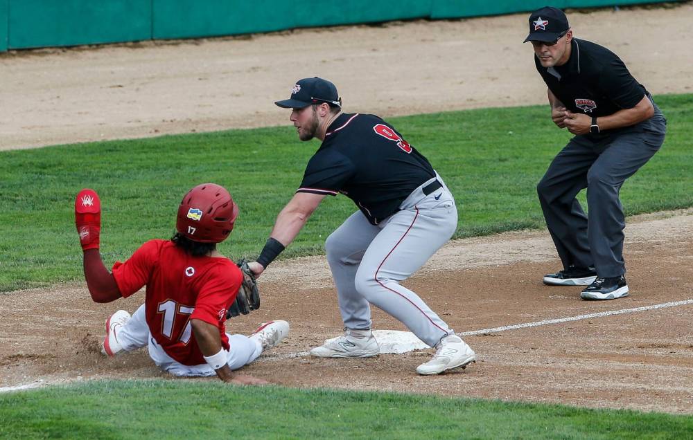 Winnipeg Goldeyes' Roby Enriquez gets tagged out at third by Sioux City Explorers’ Cameron Cannon as he tries to make it back after a failed attempt to steal home Sunday in Winnipeg. (John Woods / Free Press)