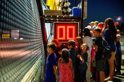 NIC ADAM / FREE PRESS 
                                Young racing fans line the fence to get a close-up view of the action.