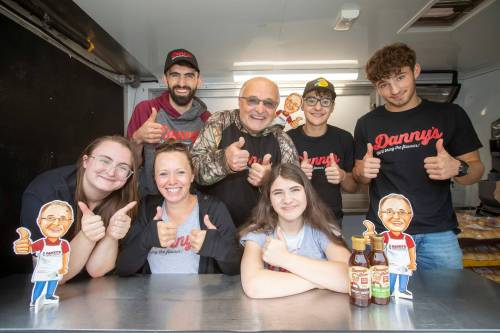 Danny Kleinsasser with family and staff inside a food truck that Danny's uses for catering. In 2023, the company served some 80,000 people. (Brook Jones / Free Press)
