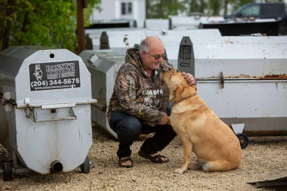 Danny Kleinsasser, seen with his three-year-old yellow Labrador retriever, was raised on the Concord Hutterite Colony near Stony Mountain but he and his wife, Jeanette, left in February, 2001. (Brook Jones / Free Press)