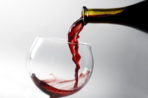 Glass of red wine being poured from the bottle. (Kirk McKoy/Los Angeles Times/TNS)