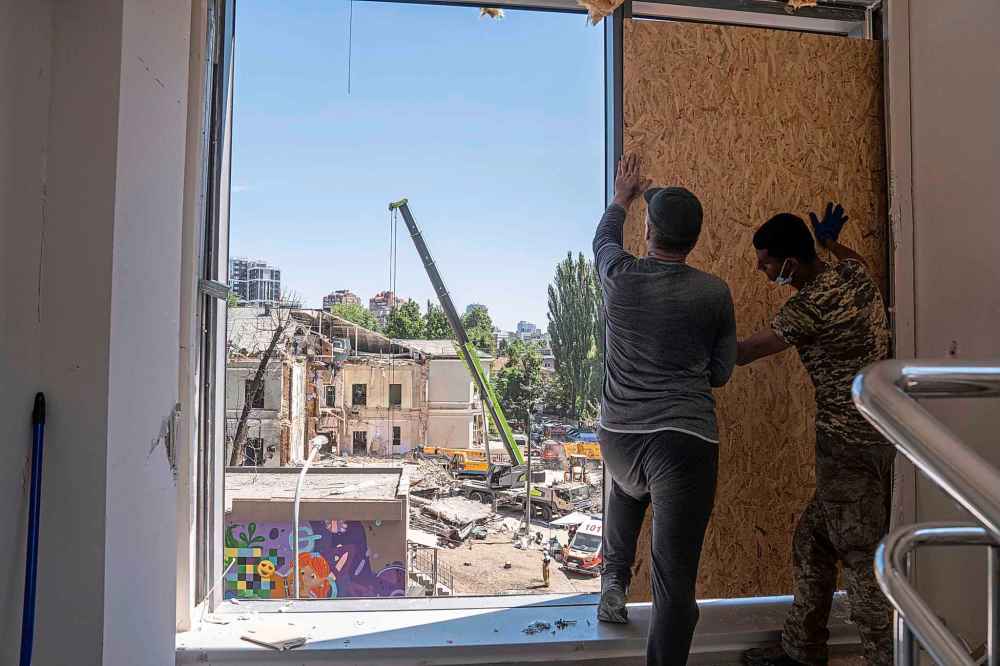 Volunteers board up windows inside of Okhmatdyt children's hospital hit by Russian missiles on Monday, in Kyiv, Ukraine, in July. (Evgeniy Maloletka / The Associated Press files)