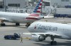 FILE - American Airlines passenger jets prepare for departure, July 21, 2021, near a terminal at Boston Logan International Airport in Boston. (AP Photo/Steven Senne, File)