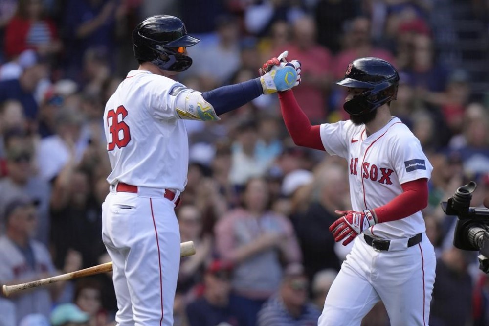 Boston Red Sox's Connor Wong, right, is welcomed by Triston Casas, left, as he scores on his home run in the second inning of a baseball game, Sunday, Sept. 8, 2024, in Boston. (AP Photo/Steven Senne)
