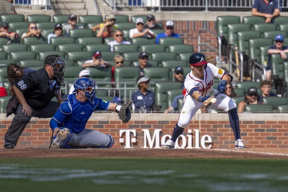 Atlanta Braves outfielder Eli White (36) hits a bunt in the 11th inning of a baseball game between the Toronto Blue Jays and the Atlanta Braves, Sunday, Sept. 9, 2024, in Atlanta. (AP Photo/Erik Rank)