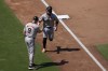 San Francisco Giants' Luis Matos, right, celebrates with third base coach Matt Williams after hitting a home run during the fourth inning of a baseball game against the San Diego Padres, Sunday, Sept. 8, 2024, in San Diego. (AP Photo/Gregory Bull)