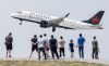 Air Canada is preparing for a potential shutdown of most operations next week as contract talks with its pilots' union near an impasse. People look on as an Air Canada plane takes off at Pierre Elliott Trudeau International Airport in Montreal, Sunday, June 11, 2023. THE CANADIAN PRESS/Graham Hughes