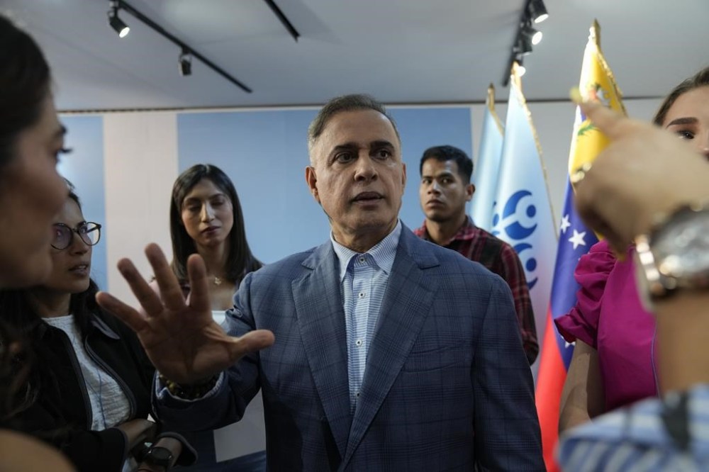 Venezuelan Attorney General Tarek William Saab speaks with the press about the opposition's former presidential candidate Edmundo Gonzalez, who left Venezuela for Spain, in Caracas, Venezuela, Sunday, Sept. 8, 2024. (AP Photo/Ariana Cabildos)