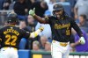Pittsburgh Pirates' Oneil Cruz (15) celebrates with Andrew McCutchen (22) as he returns to the dugout after hitting a solo home run off Miami Marlins starting pitcher Valente Bellozo during the first inning of a baseball game in Pittsburgh, Monday, Sept. 9, 2024. (AP Photo/Gene J. Puskar)