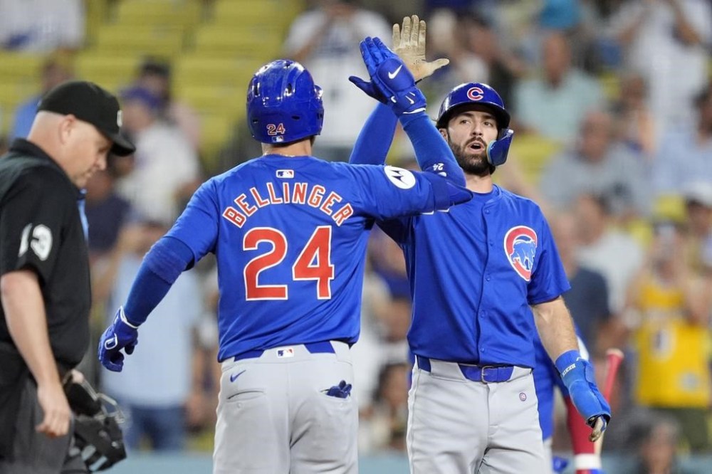 Chicago Cubs' Cody Ballinger, left, is congratulated by Dansby Swanson after hitting a two-run home run during the first inning of a baseball game against the Los Angeles Dodgers, Monday, Sept. 9, 2024, in Los Angeles. (AP Photo/Mark J. Terrill)