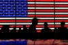 FILE - People gather near an electronic display of an American flag in Times Square in New York on Aug. 9, 2024. (AP Photo/Pamela Smith, File)