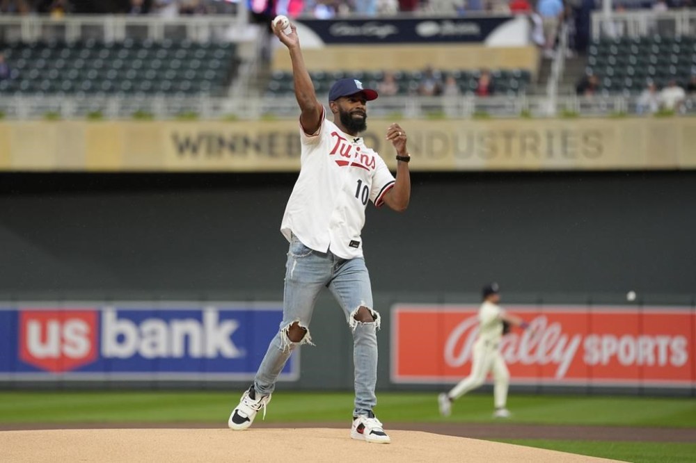 Minnesota Timberwolves guard Mike Conley throws out the first pitch before a baseball game between the Minnesota Twins and Los Angeles Angels, Tuesday, Sept. 10, 2024, in Minneapolis. (AP Photo/Abbie Parr)