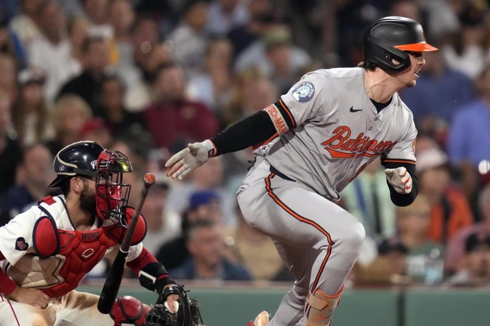 Baltimore Orioles' Adley Rutschman watches his two-RBI single during the seventh inning of a baseball game at Fenway Park, Tuesday, Sept. 10, 2024, in Boston. At left is Boston Red Sox catcher Connor Wong. (AP Photo/Charles Krupa)