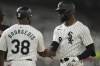 Chicago White Sox's Luis Robert Jr. high fives first base coach Jason Bourgeois after hitting a single during the third inning of a baseball game against the Cleveland Guardians, Tuesday, Sept. 10, 2024, in Chicago. (AP Photo/Melissa Tamez)