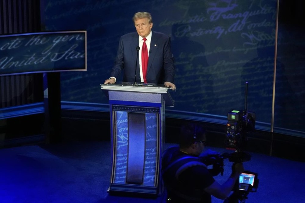 Republican presidential nominee former President Donald Trump waits at the podium during a break in the presidential debate with Democratic presidential nominee Vice President Kamala Harris at the National Constitution Center, Tuesday, Sept.10, 2024, in Philadelphia. (AP Photo/Alex Brandon)