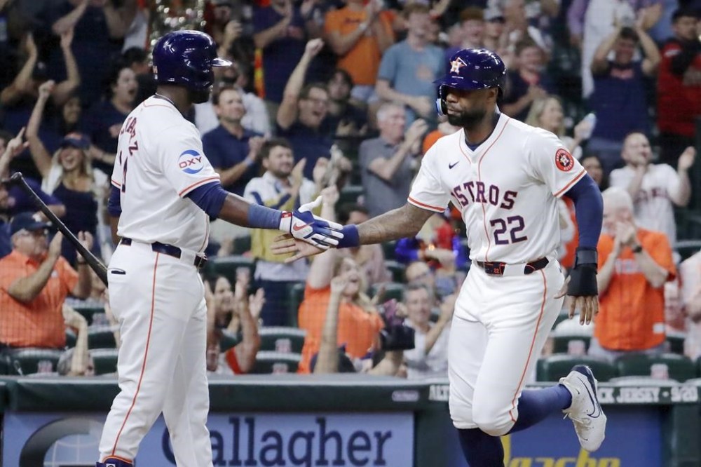 Houston Astro' Yordan Alvarez and pinch runner Jason Heyward (22) celebrate Heyward's score on the RBI single by Jose Altuve against the Oakland Athletics during the seventh inning of a baseball game, Tuesday, Sept. 10, 2024, in Houston. (AP Photo/Michael Wyke)