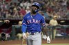 Texas Rangers' Adolis García reacts after striking out against the Arizona Diamondbacks during the fourth inning of a baseball game, Tuesday, Sept. 10, 2024, in Phoenix. (AP Photo/Darryl Webb)