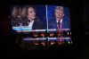 Reflected in a mirror, people watch the presidential debate between Republican presidential nominee former President Donald Trump and Democratic presidential nominee Vice President Kamala Harris, Tuesday, Sept. 10, 2024, at the Gipsy Las Vegas in Las Vegas. (AP Photo/John Locher)