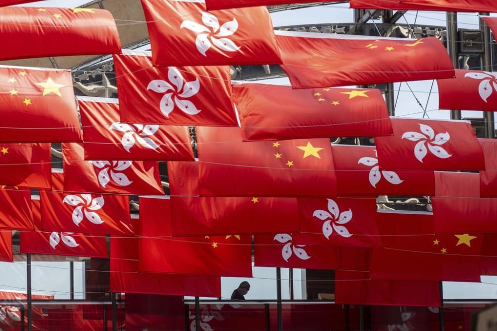 FILE - China and Hong Kong flags are hung as the city marks China's national day in Hong Kong, Sunday, Oct. 1, 2023. (AP Photo/Chan Long Hei, File)