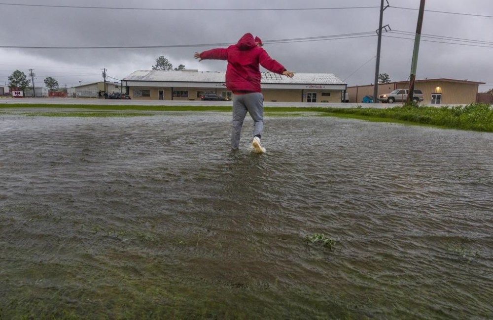 Having never before experienced the powerful forces of a hurricane, meteorologist Max Claypool of Memphis, Tenn. tries to see if the powerful winds blowing from the Hurricane Francine eye wall could lift him further in the air on Wednesday, Sept.11, 2024, Houma, La. (Chris Granger/The Times-Picayune/The New Orleans Advocate via AP)