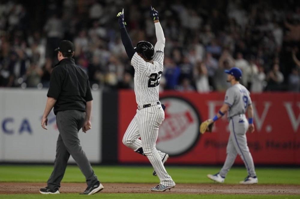 New York Yankees' Juan Soto, center, celebrates after hitting a two-run home run during the sixth inning of a baseball game against the Kansas City Royals at Yankee Stadium, Wednesday, Sept. 11, 2024, in New York. (AP Photo/Seth Wenig)