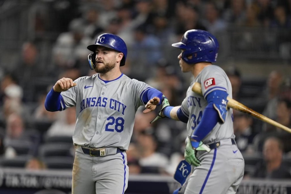 Kansas City Royals' Kyle Isbel (28), left, celebrates with Freddy Fermin after scoring on a sacrifice fly hit by Salvador Perez during the seventh inning of a baseball game at Yankee Stadium, Wednesday, Sept. 11, 2024, in New York. (AP Photo/Seth Wenig)
