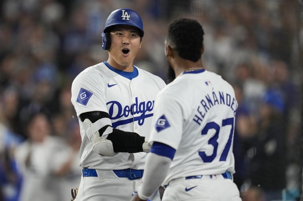Los Angeles Dodgers designated hitter Shohei Ohtani (17) celebrates with Teoscar Hernández (37) after hitting a home run during the first inning of a baseball game against the Chicago Cubs in Los Angeles, Wednesday, Sept. 11, 2024. (AP Photo/Ashley Landis)