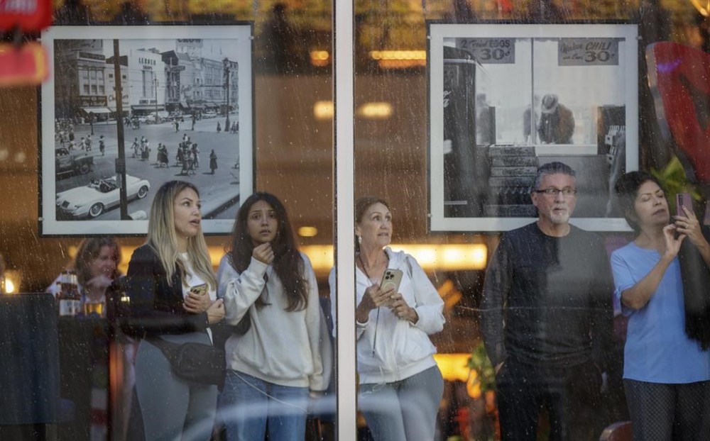 People watch Hurricane Francine from inside the Sheraton on Canal Street in New Orleans, Wednesday, Sept. 11, 2024. (David Grunfeld/The Times-Picayune/The New Orleans Advocate via AP)