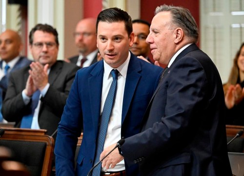 Quebec Justice Minister Simon Jolin-Barrette is congratulated by Quebec Premier Francois Legault, right, after he tabled legislation to protect consumers, Thursday, Sept. 12, 2024, at the legislature in Quebec City. THE CANADIAN PRESS/Jacques Boissinot