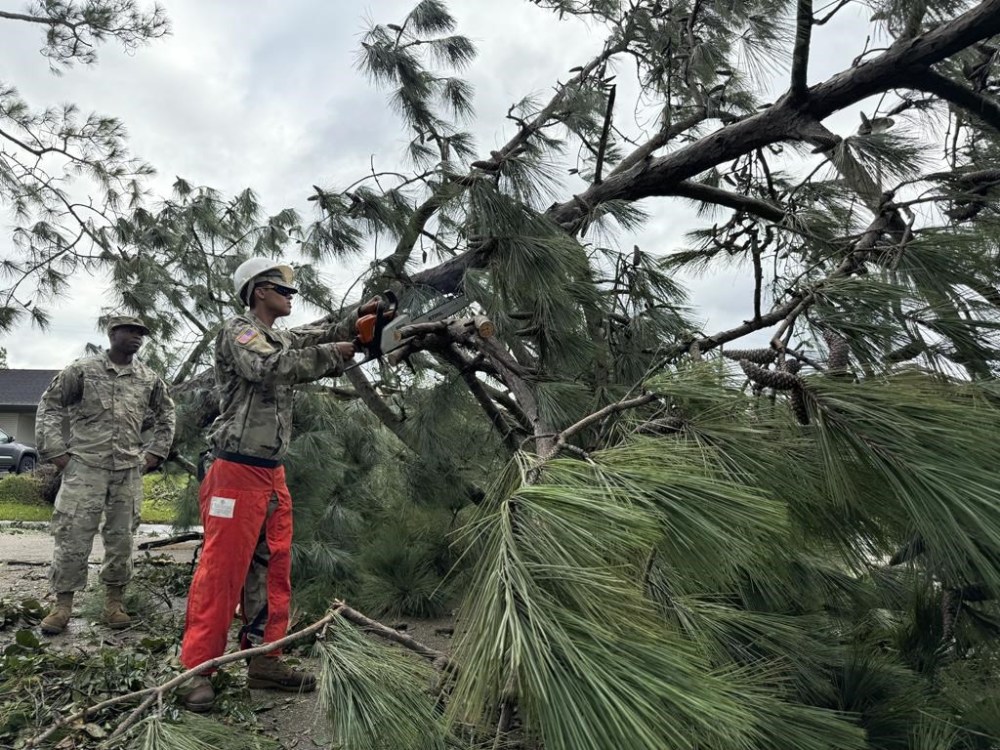National Guardsmen clear trees after arriving in Morgan City, La., on Thursday, Sept. 12, 2024 after Hurricane Francine. (AP Photo/Jack Brook)