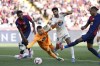Valladolid's goalkeeper Karl Hein, bottom, fails to save a goal by Barcelona's Raphinha, right, during the Spanish La Liga soccer match between FC Barcelona and Valladolid at the Olympic stadium in Barcelona, Spain, Saturday, Aug. 31, 2024. (AP Photo/Joan Monfort)